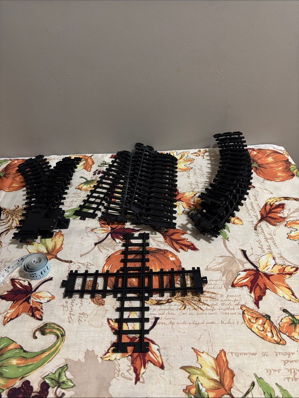 Lot of black plastic train track pieces. Includes straight, curved, and crossing